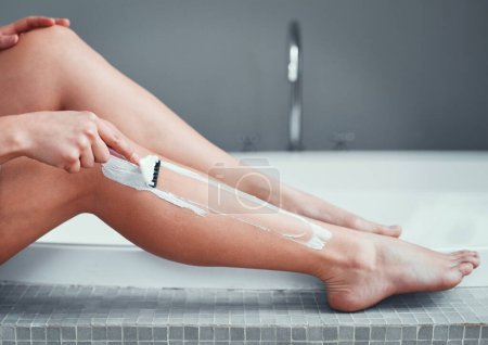 Photo for Legs, shaving razor and woman in home bathroom for hair removal, epilation and self care. Female person with hand for skincare, cleaning body and grooming with foam or soap for health and wellness. - Royalty Free Image