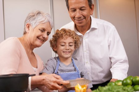 Photo for Smile, happy boy or grandparents teaching cooking skills for healthy dinner with vegetables diet at home. Learning, young male child helping or grandmother with old man, kid or food meal in kitchen. - Royalty Free Image