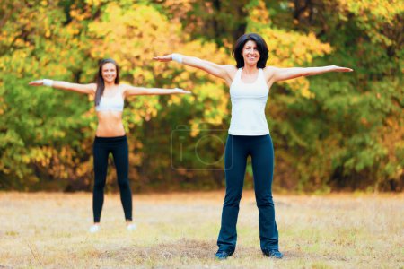 Photo for Women, arm stretching and portrait in a outdoor park for yoga and fitness. Health, wellness and arms exercise of female friends in nature on grass feeling happy with smile from body and sport. - Royalty Free Image