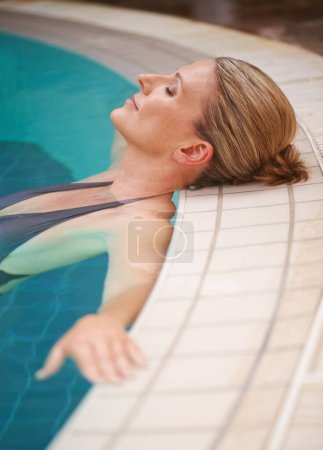 Photo for Swimming pool, calm and woman relax on holiday, summer vacation and weekend getaway. Travel, luxury spa hotel and happy female person relaxing in water for happiness, wellness and peace outdoors. - Royalty Free Image