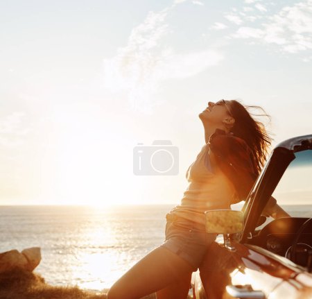 Téléchargez les photos : La route ouverte est l'endroit où il faut être. une jeune femme heureuse profitant d'un road trip estival - en image libre de droit