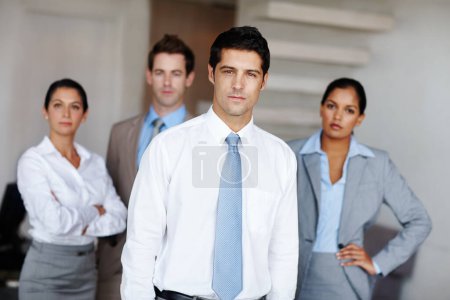 Photo for Determined to lead his team to success. A young business leader standing in front of his successful team confidently - Royalty Free Image