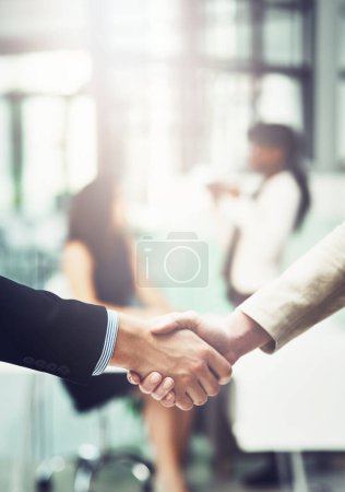 Photo for Partnership, handshake and business people in office for a deal, collaboration or corporate meeting. Teamwork, introduction and closeup of employees shaking hands for greeting or welcome in workplace. - Royalty Free Image