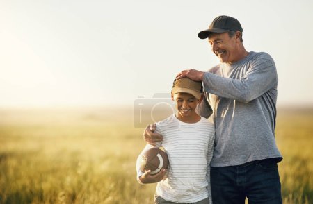 Photo for Father, son and rugby ball in a countryside field for bonding and fun in nature. Mockup, dad and young child together with happiness and smile ready to start American football game outdoor on farm. - Royalty Free Image