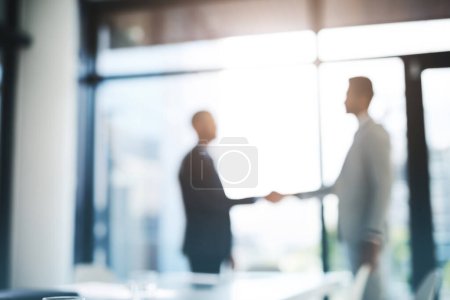 Business people, handshake and partnership for meeting, hiring or b2b deal agreement at office. Businessman shaking hands in recruiting, teamwork or collaboration with blurred background at workplace.