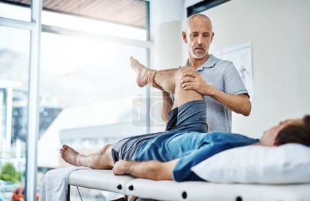 Photo for Physical therapy, healing and patient with pain, leg and recovery with injury, accident and consultation. Male person, employee or chiropractor with customer, healthcare and physiotherapist with care. - Royalty Free Image