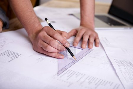 Photo for Hes a skilled draftsman. a draftsman drawing up building plans using a triangle - Royalty Free Image