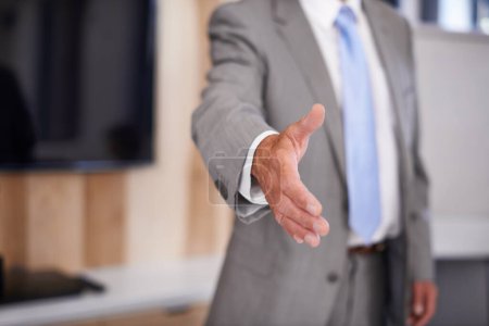 Photo for Welcome to the company. a businessman extending his arm towards the camera for a handshake - Royalty Free Image