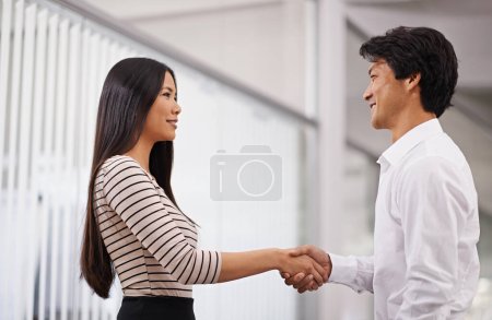 Photo for The start of a prosperous business relationship. Side view of two business partners shaking hands - Royalty Free Image