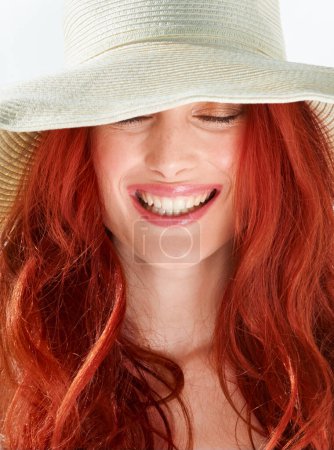 Photo for Happy woman, face and ginger or red hair with straw hat in studio, isolated white background and beautiful style. Female model with happiness and closeup of cool summer accessory, fashion and beauty. - Royalty Free Image