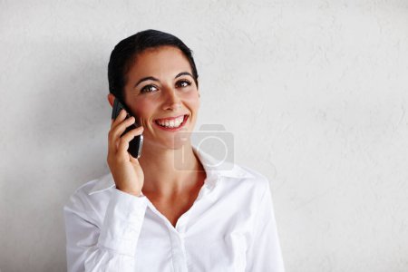 Photo for Shes always available - Financial consultant. Portrait of a pretty businesswoman taking a call - Royalty Free Image