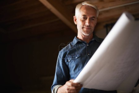 Photo for He couldnt wait to say I made this. a senior man holding a blueprint - Royalty Free Image