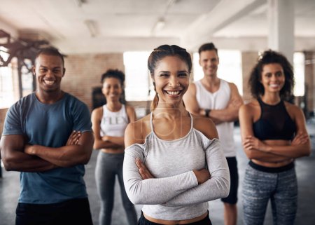 Photo for Workout with the favourites. Portrait of a group of confident young people working out together in a gym - Royalty Free Image