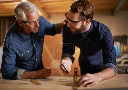 Photo for Am I doing this right. a father and son working together in a workshop - Royalty Free Image
