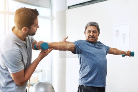 Dumbbells, physiotherapy and help with doctor and patient for rehabilitation, training and stretching. Healthcare, wellness and healing with old man and expert for consulting, muscle and exercise.