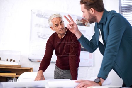 Photo for We have two options here...two male architects working together in their office - Royalty Free Image