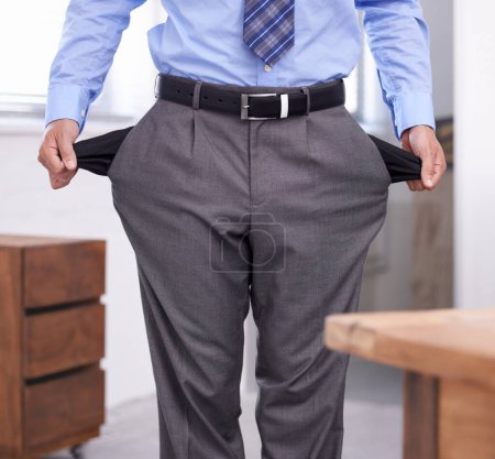 Photo for Feeling the debt crisis. a businessman showing you his empty pockets - Royalty Free Image