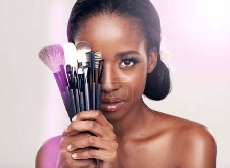 Photo for Cosmetics, makeup and portrait of black woman with brushes in studio with cosmetic application tools. Skincare, flare and skin care, face of beauty model with luxury contour brush on white background. - Royalty Free Image