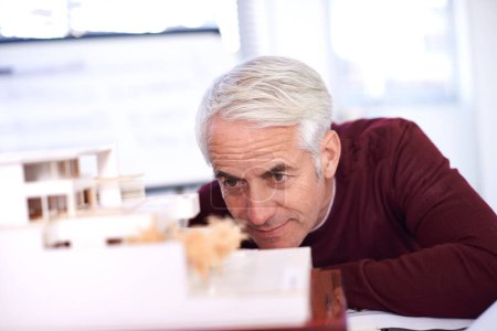 Photo for He has a keen eye for detail. a mature architect working on a scale model of a building - Royalty Free Image