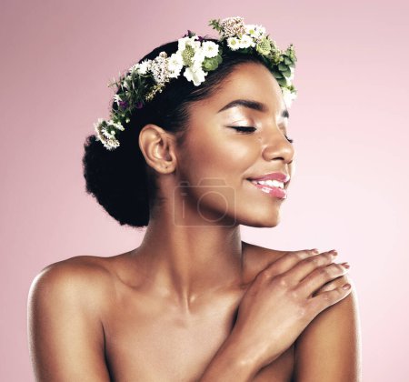 Photo for Happy woman, crown of flowers and makeup in studio, pink background and natural skincare aesthetic. African face, female model and floral headband for beauty, sustainable cosmetics and spring fashion. - Royalty Free Image