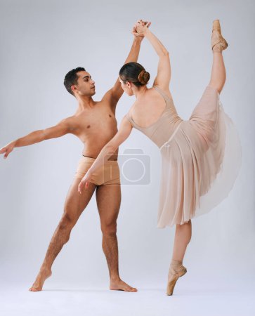 Téléchargez les photos : .Ballet dancing couple, studio and holding hands for balance, finesse and art movement for beauty in class. Young dancer team, performance or man with woman in class for fitness, teamwork and focus - en image libre de droit