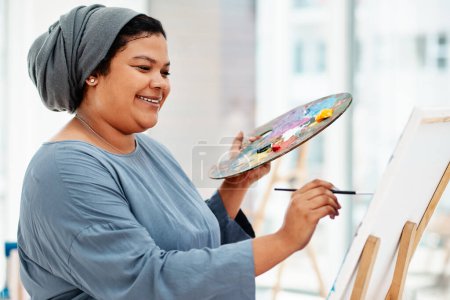 Photo for There is no right or wrong to art. an attractive young artist standing alone and painting during an art class in the studio - Royalty Free Image