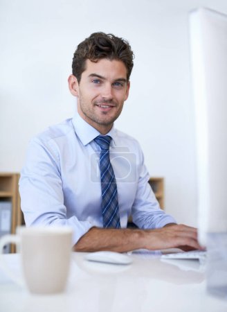 Photo for Lets do business. A young businessman sitting at his desk and looking positive - Royalty Free Image