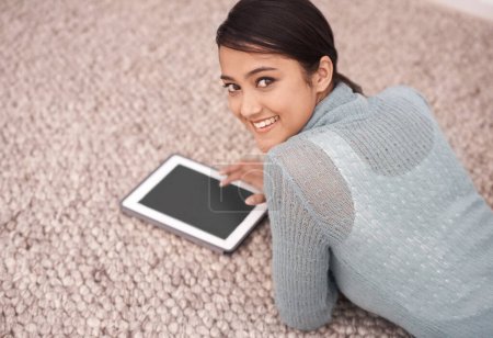 Photo for So small I can take it any where. An attractive young woman surfing the net on her digital tablet - Royalty Free Image