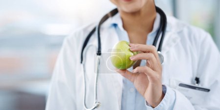 Photo for Doctor, hands and woman with apple for healthy diet, nutrition or wellness. Medical professional, nutritionist or person with fruit for vitamin c, healthcare or natural food for vegan health benefits. - Royalty Free Image