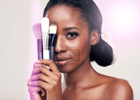 Photo for Beauty, makeup brushes and portrait of black woman with cosmetics on face in studio with application tools. Skincare, brush and cosmetic skin care model with luxury contour tool on white background - Royalty Free Image