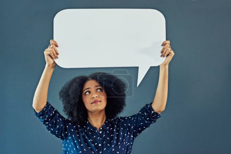 Photo for Mockup, speech bubble and woman in studio with banner for news, social media or advertising on blue background. Space, billboard and female person with paper, poster and branding promotion or launch. - Royalty Free Image
