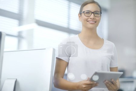 Photo for Looking to the future. an attractive young businesswoman using a digital tablet - Royalty Free Image