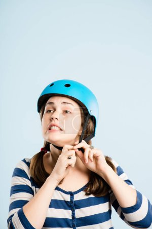 Photo for It never works when you need it to. an attractive young woman sitting alone in the studio and putting a helmet on - Royalty Free Image