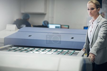 Photo for Perfecting the printing process. a manager standing over a machinery while standing on a printing factory floor - Royalty Free Image