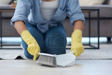 Photo for Closeup, hand broom and woman sweeping, home and spring cleaning with chores, maid and dirt. Zoom, female person and girl with housekeeping, cleaner and messy with dustpan, domestic lady and tidy. - Royalty Free Image