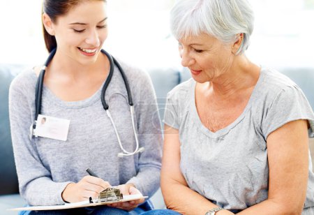 Photo for Health, checklist and senior woman care with nurse for insurance and medical consultation. Elderly female patient, healthcare worker and smile in a hospital and clinic with medic paperwork and help. - Royalty Free Image