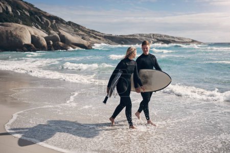 Photo for Youre my favourite person to catch waves with. a young couple out surfing together at the beach - Royalty Free Image