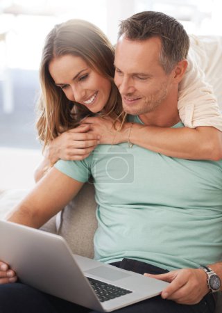 Photo for Laptop, sofa and happy couple with home internet for online planning, website review and check application together. Hug, love and affection of mature woman, partner or people on computer technology. - Royalty Free Image
