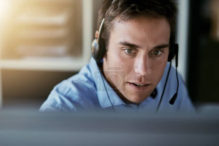 Telemarketing agent, focus and man consulting with advice, sales or help desk worker with headset. Phone call, conversation and customer support consultant, crm service agency listening on headphones.