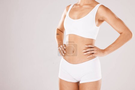 Téléchargez les photos : Fitness, health and body care, woman in underwear on studio background with motivation for healthy lifestyle. Diet, nutrition and wellness mindset, girl with self care in mockup and product placement. - en image libre de droit