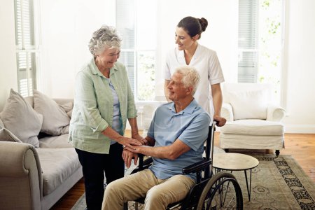 Photo for Smile, old man in wheelchair with wife and nurse at nursing home for disability help and rehabilitation. Healthcare, disability and happy senior couple with caregiver in living room for elderly care - Royalty Free Image