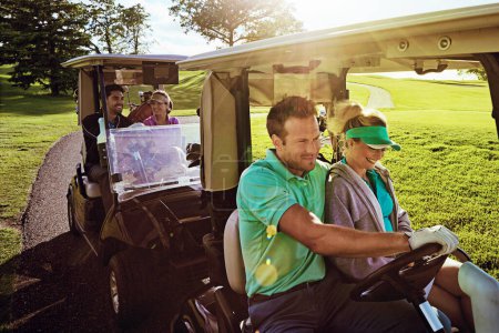 Photo for Time on the greens is time well spent. a group of friends riding in a golf cart on a golf course - Royalty Free Image