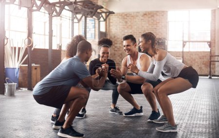 Photo for Get ready for strong glutes. a group of young people doing squats together during their workout in a gym - Royalty Free Image