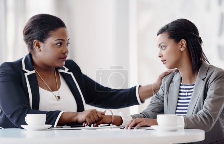 Photo for I understand if you need a few days off. an attractive young businesswoman being consoled by a female colleague in their workplace - Royalty Free Image