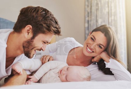 Photo for Portrait of happy mother, father and baby in bedroom for love, care and quality time to relax together in house. Mom, dad and smile with cute infant kid for happiness, support and newborn development. - Royalty Free Image