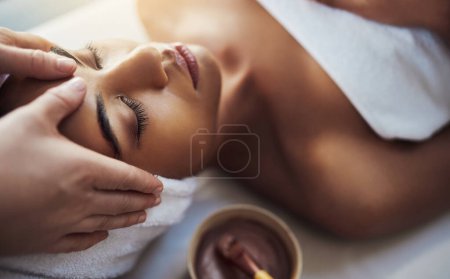 Photo for Woman, hands and face massage at spa in relax for skincare beauty treatment on bed at resort. Calm female relaxing with eyes closed or resting in physical therapy, healthy wellness or cosmetic facial. - Royalty Free Image