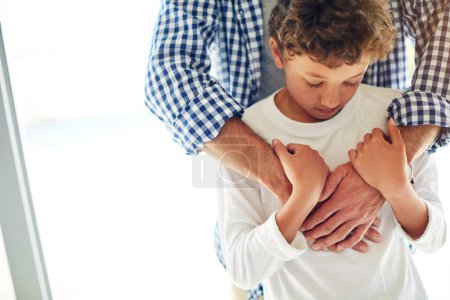 Photo for Sad, depression and care of a father and son together for comfort, love and support at home. Depressed, empathy and anxiety or mental health problem of a boy child with a man for family compassion. - Royalty Free Image