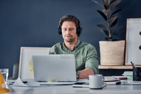 Photo for Music headphones, man and architect on laptop in office streaming radio podcast. Computer, audio or male designer listening to sound or song and working on design, research or engineering floor plan. - Royalty Free Image