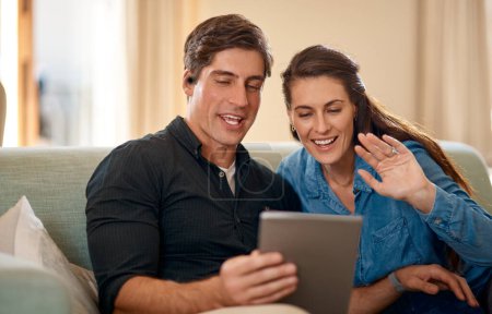 Photo for Young couple, sofa and video call on tablet with wave, hello and smile for communication on internet app. Man, woman and happy for talking, chat or hello on social media, web and relax in home lounge. - Royalty Free Image