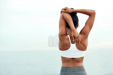 Photo for Woman, back stretching and outdoor for yoga, workout and training with mockup space. Wellness, nature and ocean with female person doing exercise for health and relax by the sea with stretch arms. - Royalty Free Image
